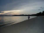Amber walking along beach during sunrise
